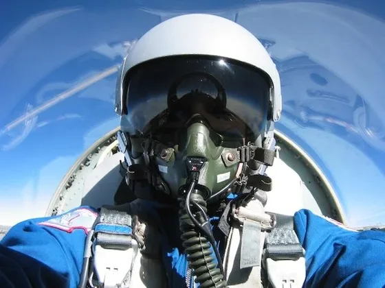 Pilot in helmet and oxygen mask in a T-38 cockpit